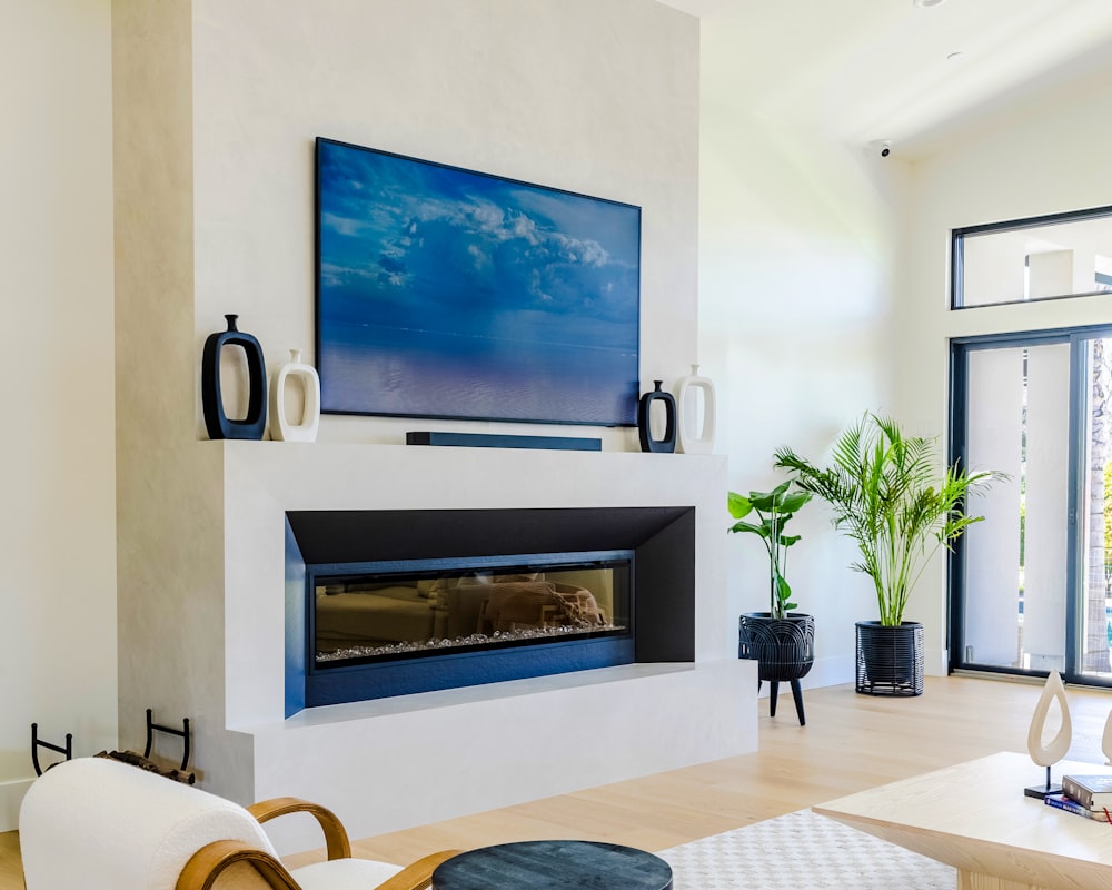 Frame-style TV displayed like art above a modern fireplace