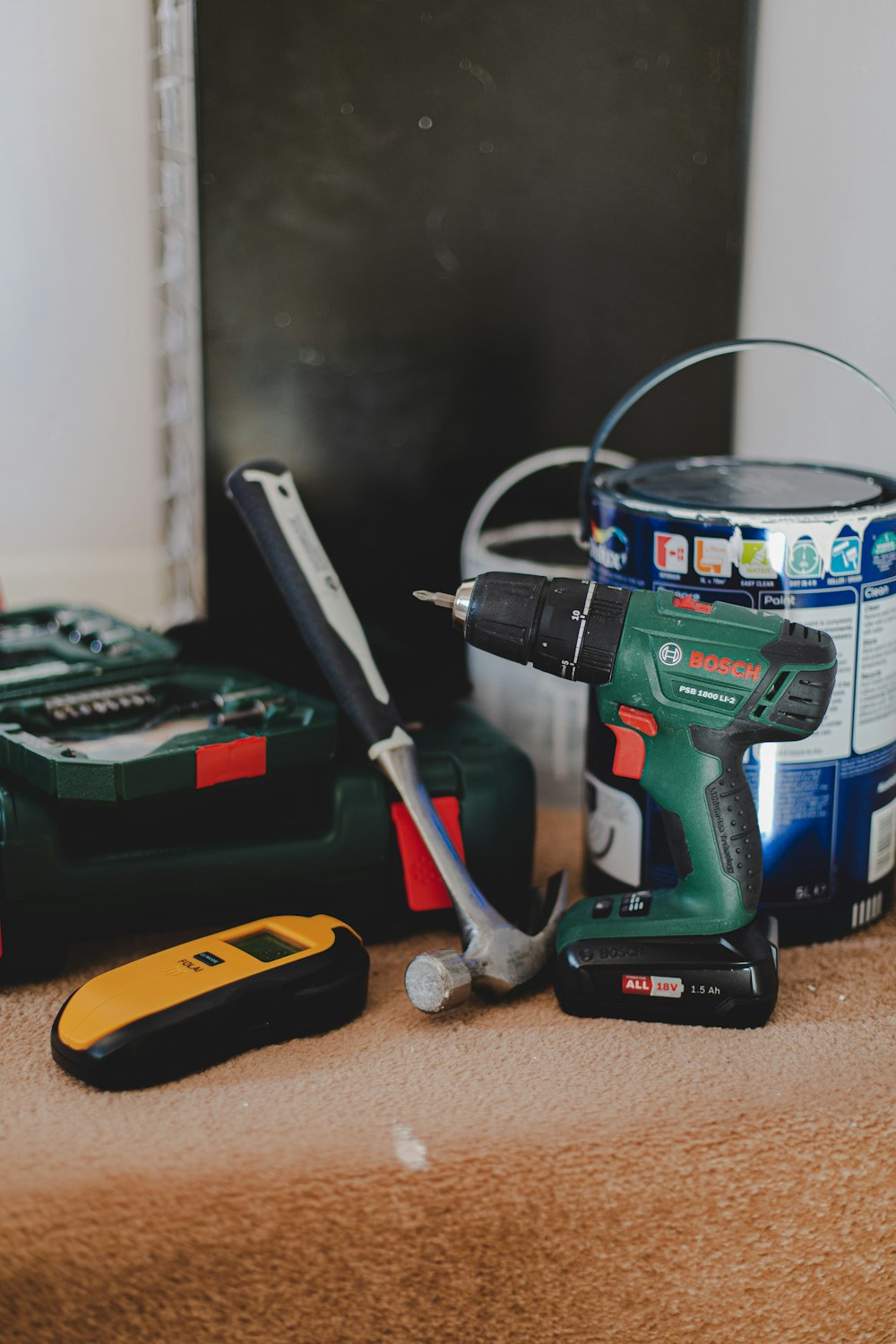 Stud finder, drill, and mounting tools ready for an installation